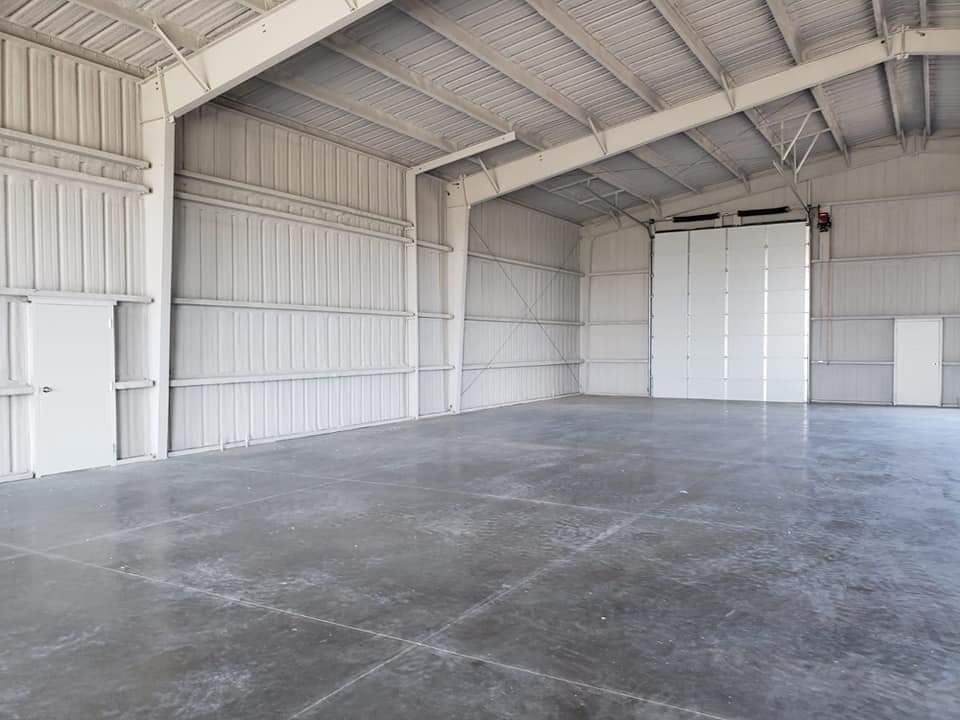 Insulated metal building interior with a finished concrete floor