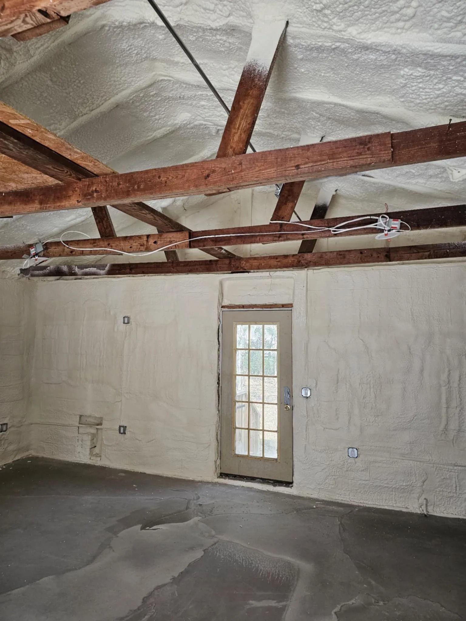 Spray foam insulation across a residential roof deck