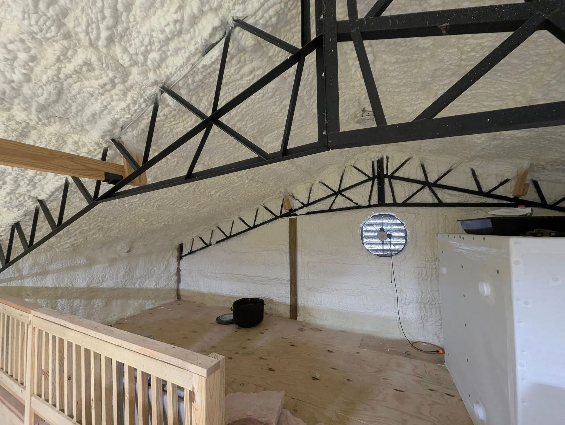 Completed spray foam insulation across a commercial metal building roof