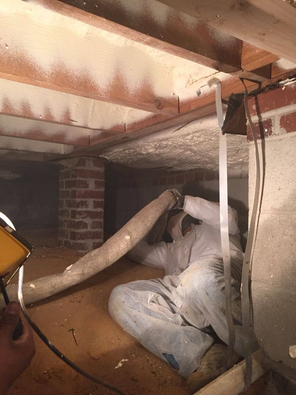 Volunteer FoamPros technician spraying foam insulation in a Middle Tennessee crawl space